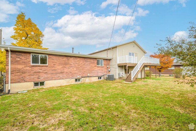 1837 N 440 W, Layton, UT 84041 - back of house featuring stairs, central AC unit, a deck, a lawn, and brick siding