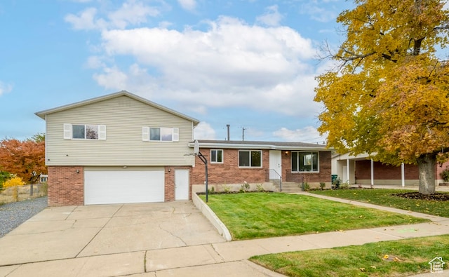 1837 N 440 W, Layton, UT 84041 - split level home featuring brick siding, an attached garage, driveway, and a front lawn