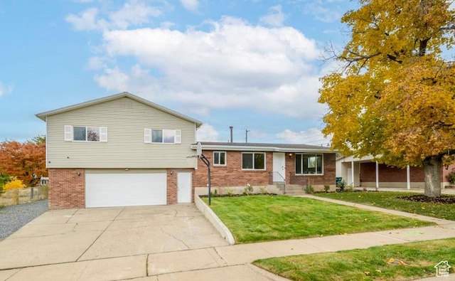 1837 N 440 W, Layton, UT 84041 - tri-level home with brick siding, a garage, driveway, and a front lawn