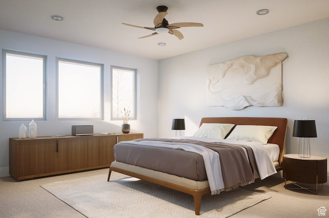 bedroom with ceiling fan and light carpet