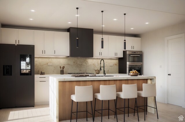 kitchen with white cabinets, hanging light fixtures, a kitchen island with sink, and black refrigerator with ice dispenser