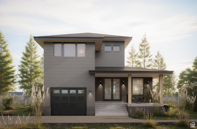 view of front of home featuring a porch and a garage