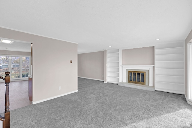4866 Adams Ave, South Ogden, UT 84403 - unfurnished living room featuring carpet flooring, an inviting chandelier, built in features, a textured ceiling, and a tiled fireplace