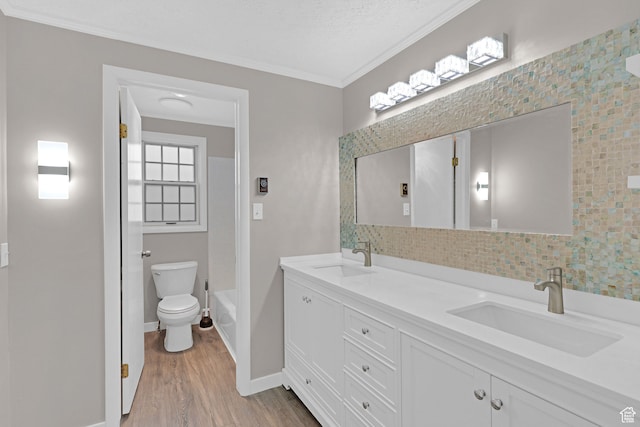 4866 Adams Ave, South Ogden, UT 84403 - full bathroom with hardwood / wood-style flooring, vanity, toilet, and crown molding