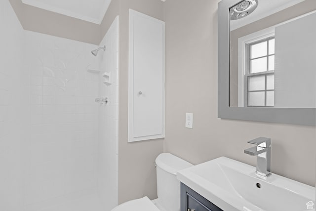 4866 Adams Ave, South Ogden, UT 84403 - bathroom with tiled shower, vanity, toilet, and ornamental molding
