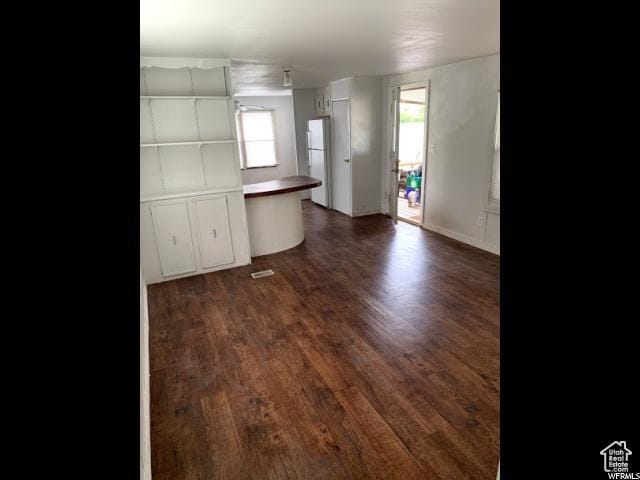 18120 N 4400 W, Fielding, UT 84311 - kitchen featuring plenty of natural light, dark wood finished floors, and freestanding refrigerator