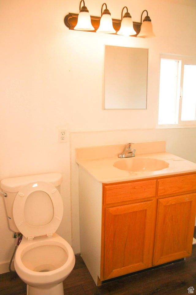 18250 N 4400 W, Fielding, UT 84311 - half bath with vanity, toilet, and wood finished floors