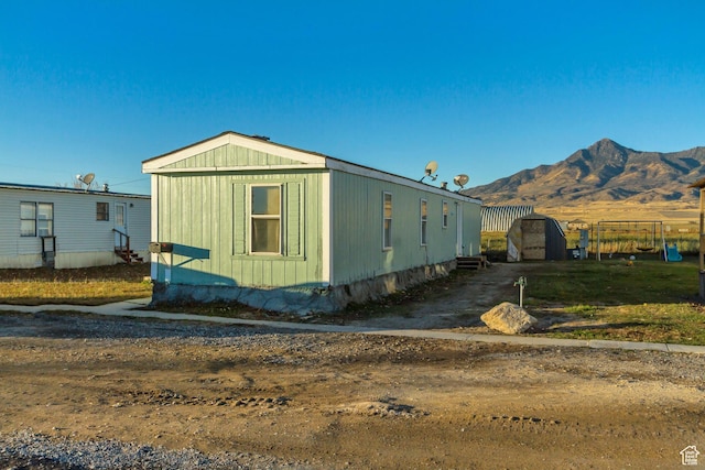 18250 N 4400 W, Fielding, UT 84311 - view of side of home featuring a mountain view and entry steps