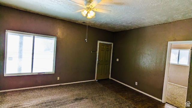 18250 N 4400 W, Fielding, UT 84311 - empty room featuring ceiling fan, dark carpet, baseboards, and a textured ceiling