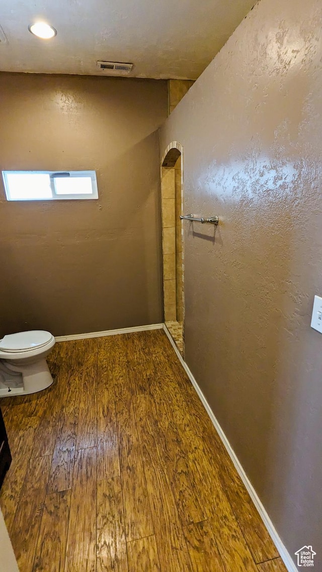 18250 N 4400 W, Fielding, UT 84311 - bathroom with wood-type flooring, toilet, and baseboards