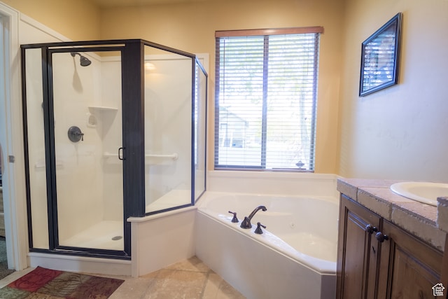 bathroom with tile patterned flooring, vanity, and shower with separate bathtub