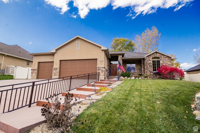 ranch-style house with a garage and a front lawn