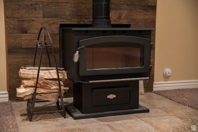 interior details with a wood stove and wood walls