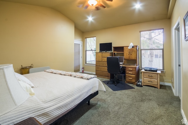 carpeted bedroom featuring multiple windows, ceiling fan, and lofted ceiling