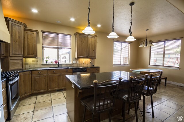 kitchen featuring backsplash, a kitchen island, and stainless steel appliances