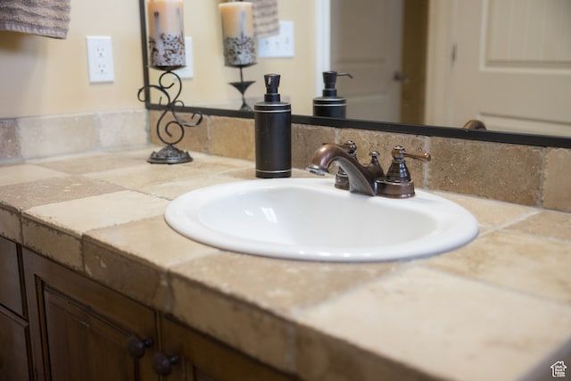 bathroom with vanity and tasteful backsplash