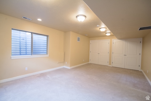 interior space featuring light carpet