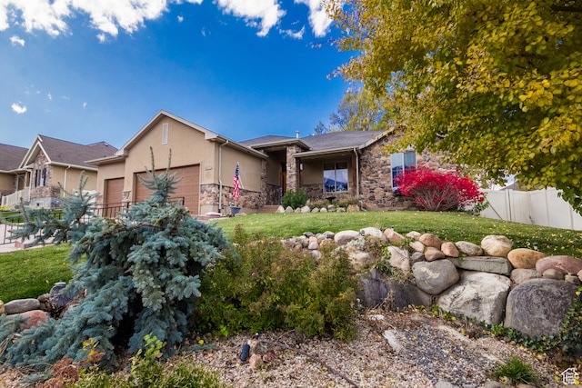 view of front of house with a garage and a front lawn