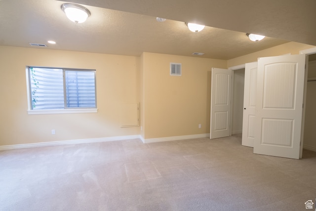 unfurnished room with light carpet