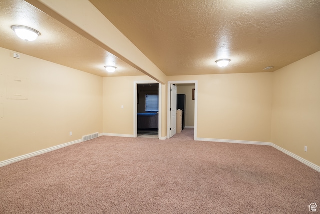 basement with carpet and a textured ceiling