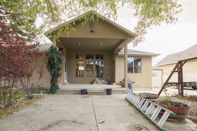 back of property featuring a patio
