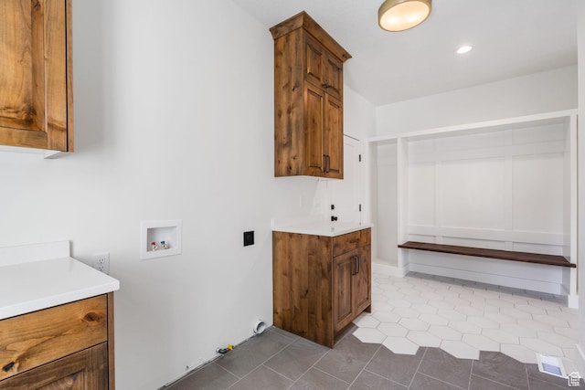 laundry area featuring dark tile patterned flooring, recessed lighting, cabinet space, gas dryer hookup, and hookup for a washing machine