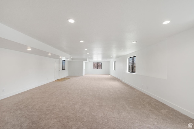interior space with recessed lighting, baseboards, and light colored carpet