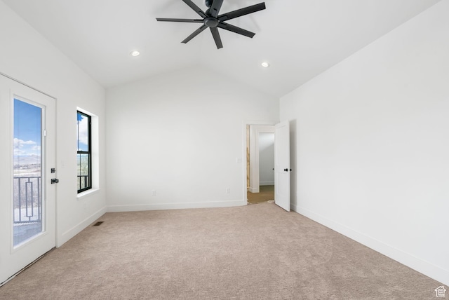 empty room with a ceiling fan, baseboards, visible vents, vaulted ceiling, and light carpet
