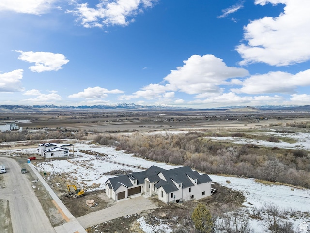 snowy aerial view with a mountain view