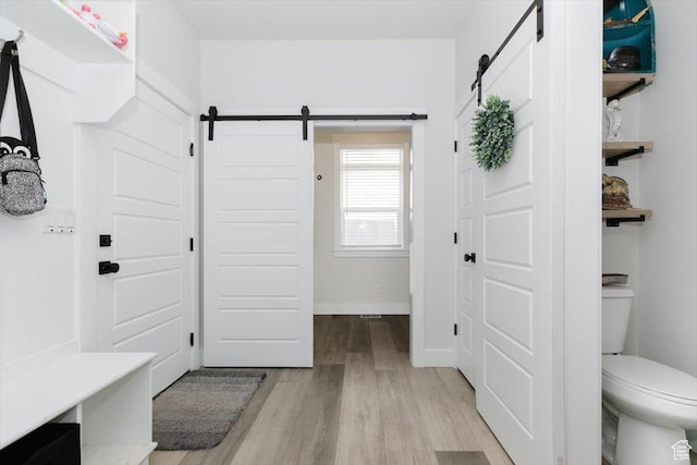 615 N 750 E, Hyde Park, UT 84318 - mudroom featuring a barn door, light wood finished floors, and baseboards
