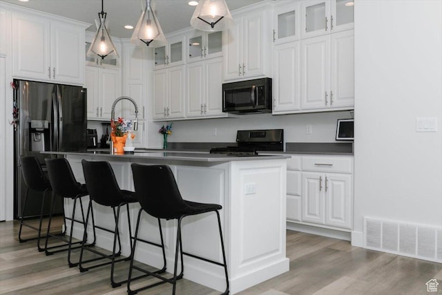 615 N 750 E, Hyde Park, UT 84318 - kitchen with black appliances, white cabinetry, dark countertops, light wood-style floors, and recessed lighting