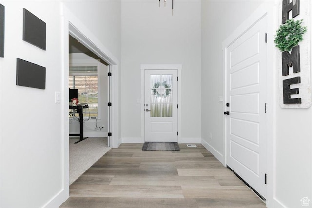 615 N 750 E, Hyde Park, UT 84318 - entryway featuring baseboards, light wood-style floors, and a towering ceiling