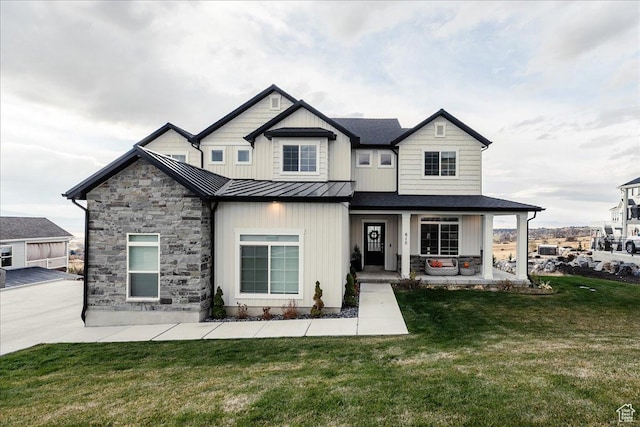 615 N 750 E, Hyde Park, UT 84318 - view of front of house with a standing seam roof, a front lawn, metal roof, a porch, and stone siding