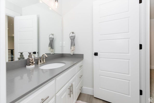 615 N 750 E, Hyde Park, UT 84318 - bathroom featuring vanity, baseboards, and wood finished floors