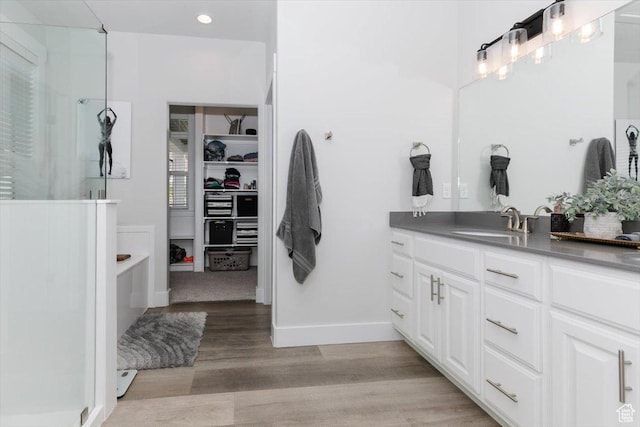 615 N 750 E, Hyde Park, UT 84318 - bathroom featuring a shower with shower door, vanity, a spacious closet, wood finished floors, and recessed lighting