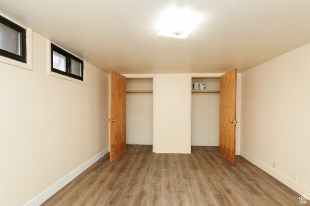 176 W 500 N, Malad City, ID 83252 - unfurnished bedroom featuring wood finished floors, baseboards, and two closets