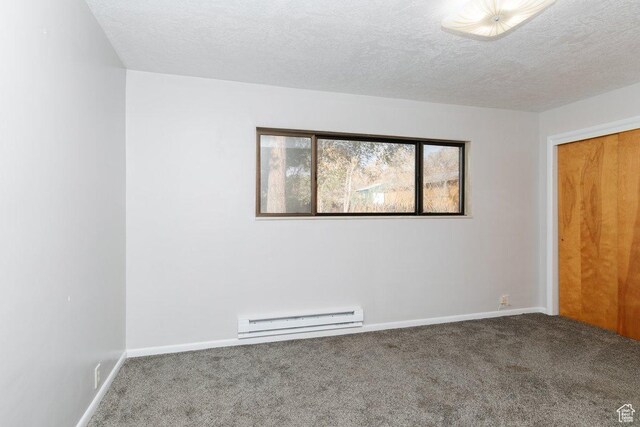 176 W 500 N, Malad City, ID 83252 - carpeted empty room with a baseboard heating unit, baseboards, and a textured ceiling