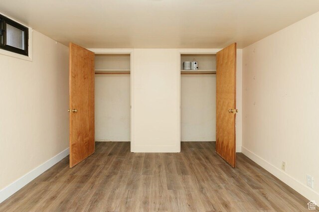 176 W 500 N, Malad City, ID 83252 - unfurnished bedroom with wood finished floors, baseboards, and multiple closets