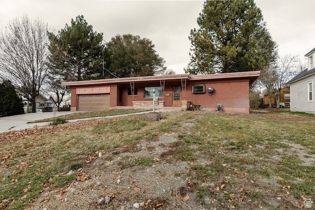 ranch-style home with a garage and a front yard