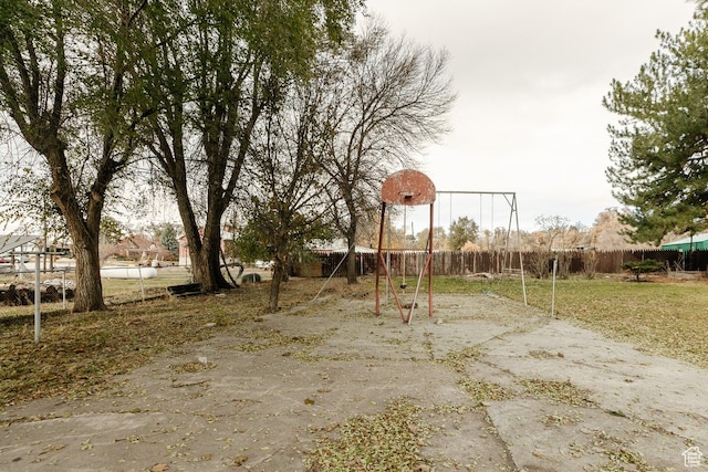 view of playground featuring basketball hoop