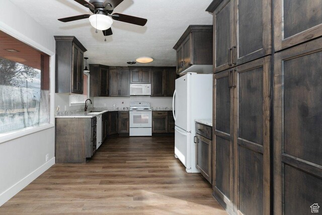 176 W 500 N, Malad City, ID 83252 - kitchen featuring white appliances, dark brown cabinets, a ceiling fan, baseboards, and a sink