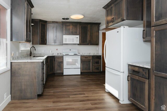 176 W 500 N, Malad City, ID 83252 - kitchen with white appliances, a sink, dark brown cabinetry, dark wood-type flooring, and light stone counters