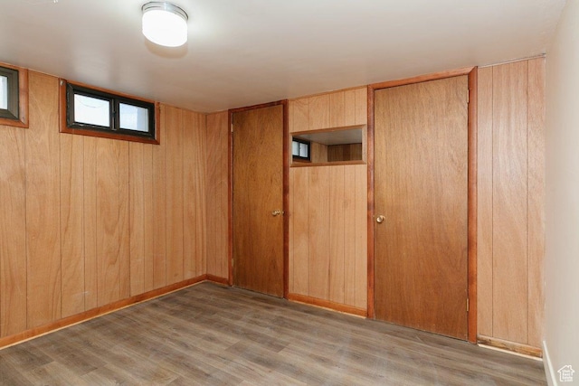 176 W 500 N, Malad City, ID 83252 - unfurnished bedroom featuring wood finished floors, wood walls, and a closet