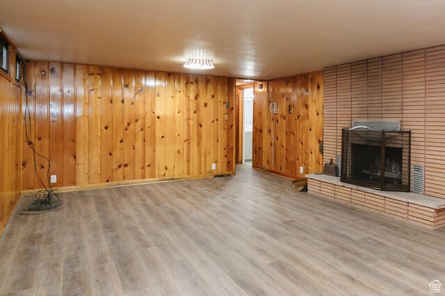 176 W 500 N, Malad City, ID 83252 - unfurnished living room with a fireplace, wood finished floors, and wooden walls