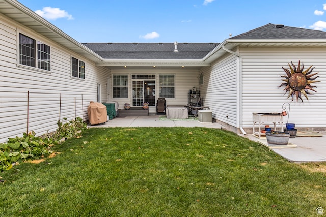 rear view of house featuring a patio area and a lawn
