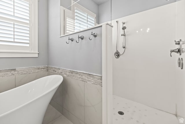bathroom with plus walk in shower and tile walls