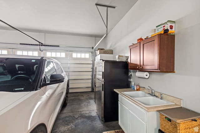 garage with sink and stainless steel refrigerator