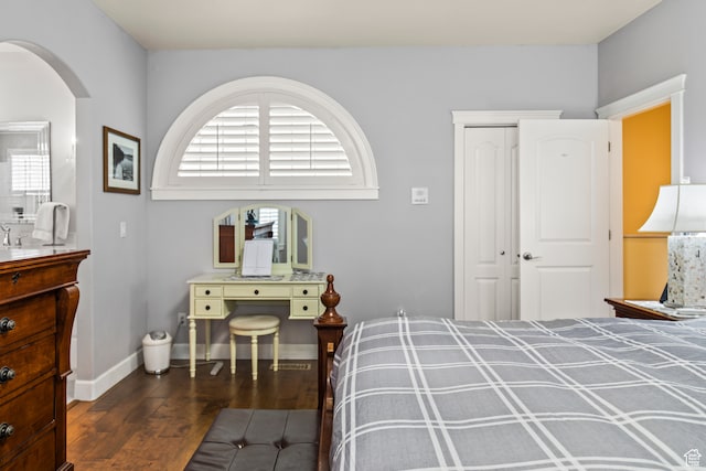 bedroom featuring dark hardwood / wood-style flooring and a closet