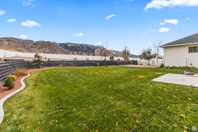 view of yard with a mountain view and a patio