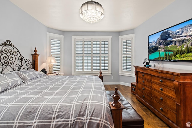 528 E 700 S Unit 4, Monroe, UT 84754 - bedroom featuring wood finished floors, baseboards, and a chandelier